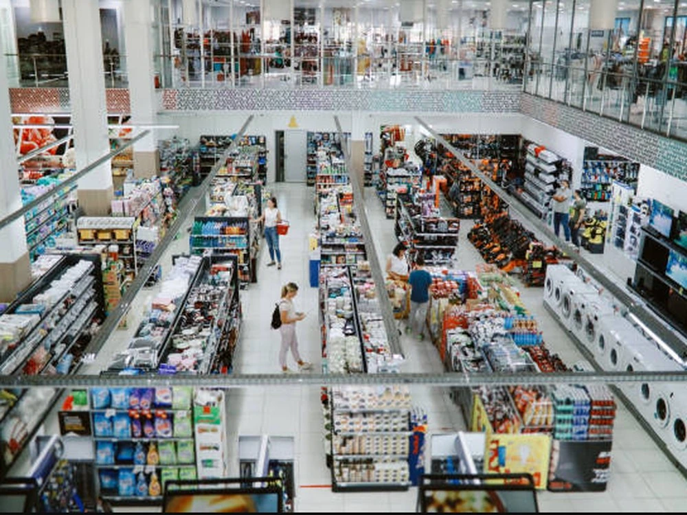 Retail store interior with shelves and shoppers